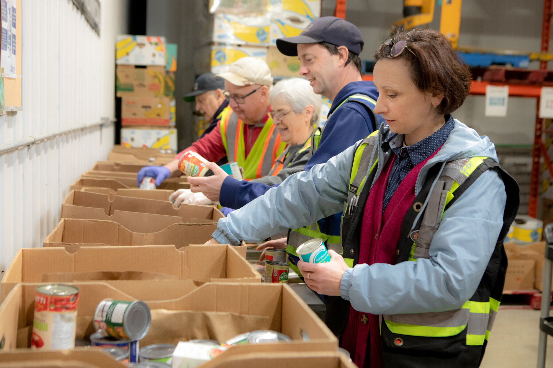 People sorting canned goods